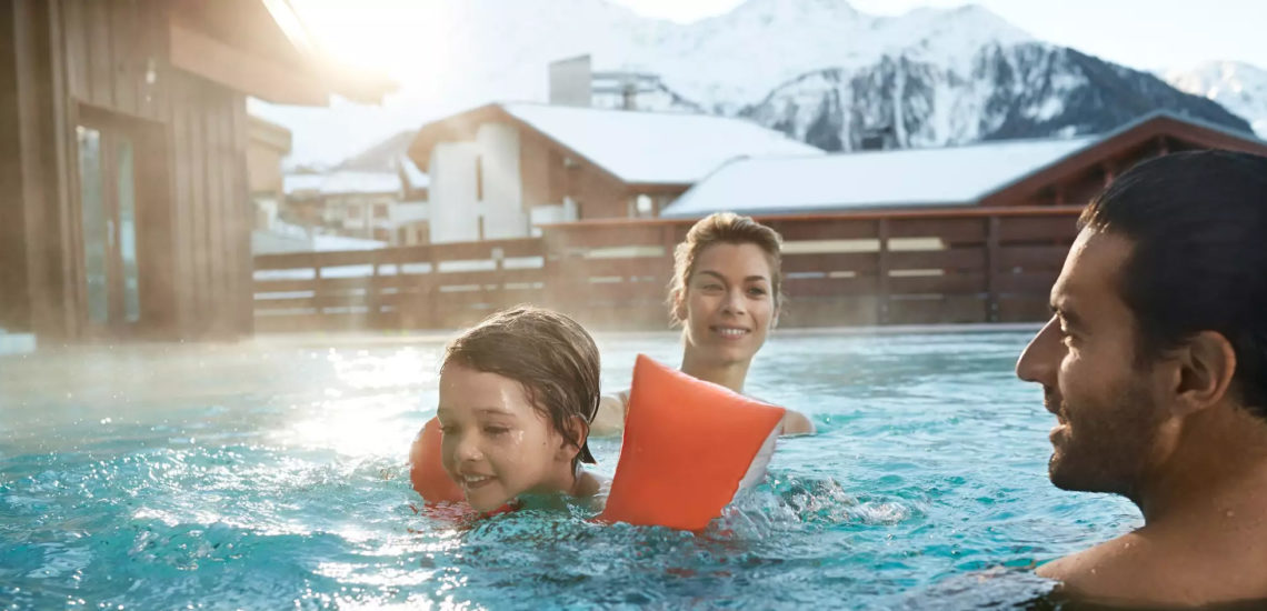 Club Med Peisey - Vallandry, en France - Une famille profite de la piscine extérieure chauffée du Village