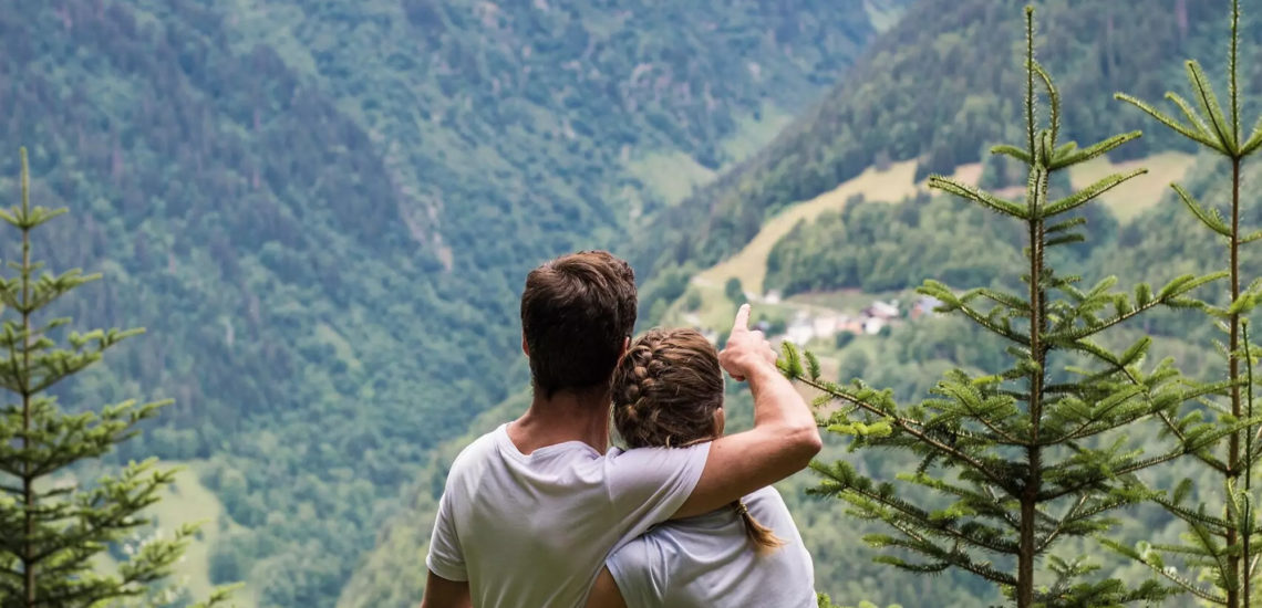 Club Med Samoëns, en France - Un couple profite, en pic de montagne, de la vue offerte de la vallée sa